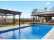A sparkling in-ground pool with an outdoor living space that has a fireplace is perfect for entertaining at 2698 E Cresthill Ave, Centennial, CO 80121