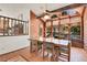 Dining area with exposed wood beams, large windows providing views, and a light fixture with a ceiling fan at 29571 Dorothy Rd, Evergreen, CO 80439