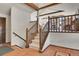 Entryway with tile flooring, staircase with wood banister, and a glimpse into the living area at 29571 Dorothy Rd, Evergreen, CO 80439