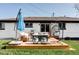 Inviting backyard with a patio lounge area and egg chair hanging from the elevated deck at 11354 Allendale Dr, Arvada, CO 80004