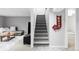 Finished basement featuring a comfortable seating area and staircase with stylish decor and lighting at 11354 Allendale Dr, Arvada, CO 80004