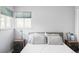 Bright bedroom featuring a comfortable bed with pillows, side tables with lamps, and large windows at 11354 Allendale Dr, Arvada, CO 80004