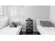 Bright bedroom with hardwood floors featuring two twin beds and a side table with books and a plant at 11354 Allendale Dr, Arvada, CO 80004