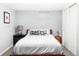 Relaxing bedroom with dark wood frame, white comforter, and contrasting black-and-white pillows at 11354 Allendale Dr, Arvada, CO 80004
