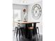 Cozy dining area featuring a unique table, black stools, a large decorative clock, and a cuckoo clock at 11354 Allendale Dr, Arvada, CO 80004