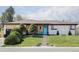 Charming home with modern wood and white facade, vibrant blue front door, and manicured landscaping at 11354 Allendale Dr, Arvada, CO 80004