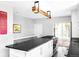 Stylish kitchen with white cabinets, stainless steel appliances, a kitchen island, and modern lighting at 11354 Allendale Dr, Arvada, CO 80004