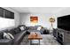 Cozy living room featuring a comfortable sectional sofa, a unique wood coffee table, and stylish decor at 11354 Allendale Dr, Arvada, CO 80004