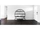 Living room features an artistic circular shelving unit and dark hardwood floors for a stylish and modern look at 11354 Allendale Dr, Arvada, CO 80004