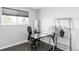 Home office featuring a sleek glass desk, comfortable chair, and plenty of natural light from the window at 11354 Allendale Dr, Arvada, CO 80004