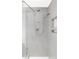 Modern shower with gray tiling, rainfall shower head, handheld sprayer, and built-in shelving at 11354 Allendale Dr, Arvada, CO 80004
