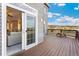 Home deck with a wood floor, sliding glass doors, an outdoor bench, and scenic views at 931 Forest View Rd, Monument, CO 80132