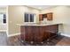 Finished basement wet bar with granite countertops, wine rack, wood cabinets, and LVP flooring at 931 Forest View Rd, Monument, CO 80132