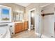 Bathroom features a vanity, tub, toilet, and a glass shower with tile accents at 931 Forest View Rd, Monument, CO 80132