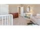 Comfortable Bedroom with rocking chair, crib, bureau, bookshelf, and lots of natural light at 931 Forest View Rd, Monument, CO 80132