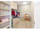 Well-organized walk-in closet with shelving, rods, drawers, and carpeted floors providing ample storage at 931 Forest View Rd, Monument, CO 80132