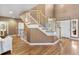 Elegant foyer with hardwood floors, a graceful staircase, and warm, inviting decor at 931 Forest View Rd, Monument, CO 80132