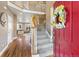 Bright foyer featuring hardwood floors, an elegant staircase, and a glimpse into the living room at 931 Forest View Rd, Monument, CO 80132