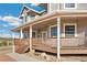 Inviting front porch with detailed railings, a cozy seating area, and prominent house numbers at 931 Forest View Rd, Monument, CO 80132
