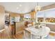 Eat-in kitchen with light wood cabinets, granite countertops, and view windows at 931 Forest View Rd, Monument, CO 80132