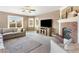 Living room featuring a fireplace, neutral colors, and lots of natural light at 931 Forest View Rd, Monument, CO 80132