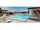 Resort-style pool area with lounge chairs, umbrellas, and a splash fountain for residents' relaxation and recreation at 3768 Backslope Ln, Castle Rock, CO 80108