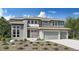 Charming two-story home with stone accents, gray siding, a well-kept yard, and a three car attached garage at 3768 Backslope Ln, Castle Rock, CO 80108