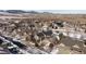 An aerial view shows snow covered roofs and neighborhood streets with a mountain backdrop at 17853 W 77Th Ln, Arvada, CO 80007
