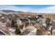 An aerial shot shows home with an attached three-car garage in a community with a mountain backdrop at 17853 W 77Th Ln, Arvada, CO 80007