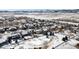 Aerial view of a snow covered neighborhood featuring many homes and snow-covered roads at 17853 W 77Th Ln, Arvada, CO 80007