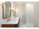 Modern bathroom boasts double vanity with a glass enclosed shower at 17853 W 77Th Ln, Arvada, CO 80007