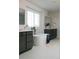 Bright bathroom with a freestanding tub, double vanity, and white tile flooring at 17853 W 77Th Ln, Arvada, CO 80007