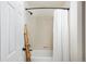 Bright bathroom with decorative wooden ladder and a shower with curtain at 17853 W 77Th Ln, Arvada, CO 80007