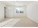Bright, open bedroom with a shuttered window and neutral carpeting at 17853 W 77Th Ln, Arvada, CO 80007
