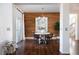 A dining area featuring a modern table and stylish chairs with a wood accent wall at 17853 W 77Th Ln, Arvada, CO 80007