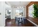 Dining area featuring a modern table, stylish chairs, and an accent wood wall at 17853 W 77Th Ln, Arvada, CO 80007