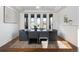 Dining room featuring a wooden table, modern chairs, and large windows offering a view of the outdoors at 17853 W 77Th Ln, Arvada, CO 80007