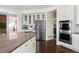 Kitchen with stainless steel appliances, granite countertops, and white cabinets at 17853 W 77Th Ln, Arvada, CO 80007