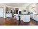 Spacious kitchen with white cabinetry, stainless steel appliances, and an island with bar seating at 17853 W 77Th Ln, Arvada, CO 80007