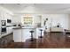 Open kitchen with granite countertops, stainless steel appliances, and dark hardwood floors at 17853 W 77Th Ln, Arvada, CO 80007