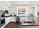 Kitchen with granite countertops, stainless steel appliances, and white cabinets at 17853 W 77Th Ln, Arvada, CO 80007