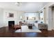 Bright living room featuring a fireplace, white sofa, stylish rug, and an abundance of natural light at 17853 W 77Th Ln, Arvada, CO 80007