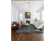 Bright living room with a fireplace, plantation shutters, and stylish contemporary furniture at 17853 W 77Th Ln, Arvada, CO 80007