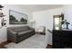 Living room with a grey sofa, decorative painting, and modern decor at 17853 W 77Th Ln, Arvada, CO 80007