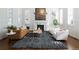 Bright living room with a fireplace, plantation shutters, and stylish contemporary furniture at 17853 W 77Th Ln, Arvada, CO 80007