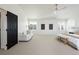 Large main bedroom featuring black doors, light walls, and neutral carpet at 17853 W 77Th Ln, Arvada, CO 80007