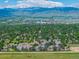 Stunning aerial view of residential area showing greenery, mountains, and blue skies at 7481 Singing Hills Dr, Boulder, CO 80301