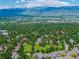 Scenic aerial view of a town with stunning mountain views, lake, and luscious trees at 7481 Singing Hills Dr, Boulder, CO 80301