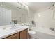 This bright bathroom features a tub and shower combination and ample vanity space at 7481 Singing Hills Dr, Boulder, CO 80301