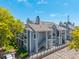 Exterior showing a multi-unit residential building with decks, gray siding, rooflines, and manicured green spaces at 7481 Singing Hills Dr, Boulder, CO 80301